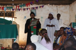 The pastor in the church in Baaba I holding the picture of the female founders of the Presbyterian church as a fetish.