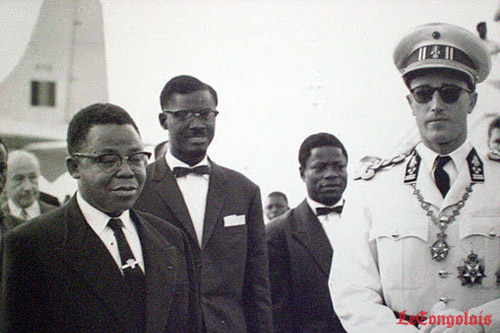  30 June 1960, then Congolese delegation (L to R): Kasa Vubu, Lumumba, Bomboko and the Belgian King Baudoin at the Brussels airport. Did the plane at the back pick up its passengers in Libenge? Source: http://www.lecongolais.cd/quavons-nous-fait-de-lindependance/ 